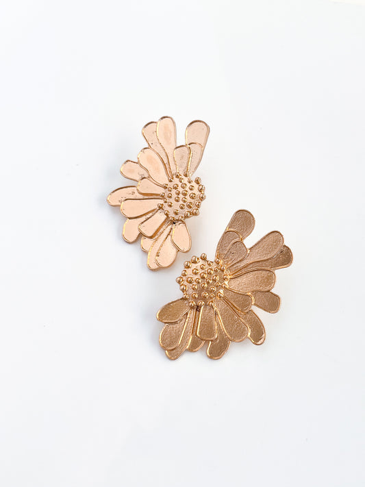 The Big Flower Stud earrings by Agave Designs feature intricately detailed gold flower-shaped petals crafted from zinc alloy, with textured centers, elegantly displayed on a plain white background.